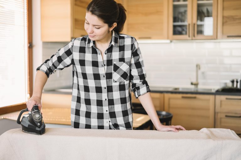 medium-shot-woman-ironing-towel