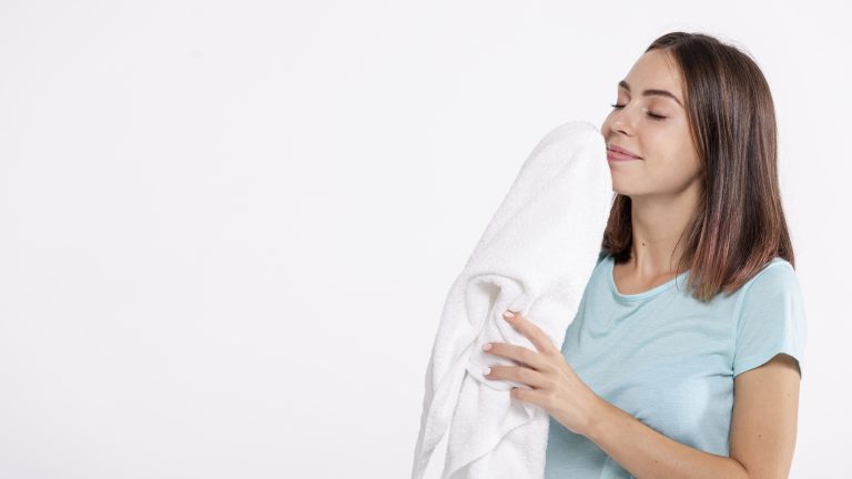 medium-shot-woman-smelling-clean-towel